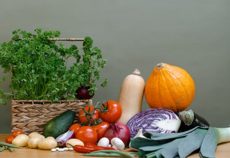 A vibrant display of fresh vegetables including tomatoes, squash, and parsley.